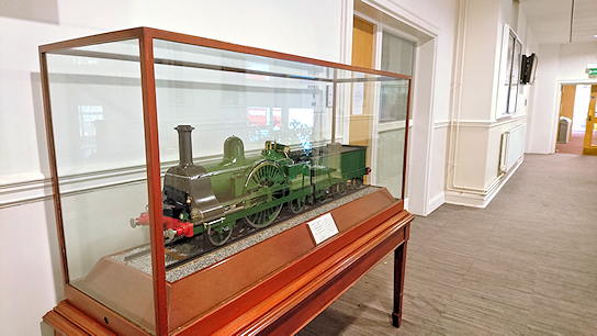 Model locomotive in a glass case in a corridor